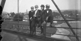 Four boys on a bridge